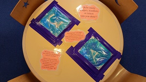 Photo of a child's play table with ziploc bags filled with gel taped to it