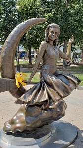 Yellow stuffed monster on the Bewitched statue in Salem