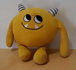 Photo of a yellow stuffed animal monster