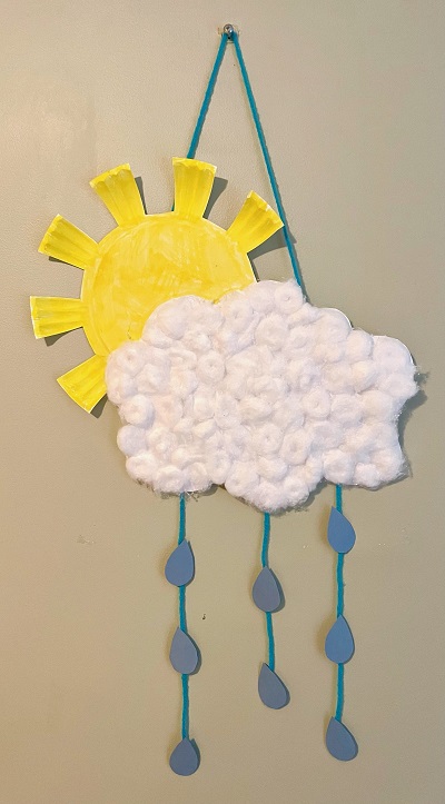 Photo of a yellow sun made of a paper plate and a white cloud made of cottonballs