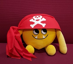 Photo of a yellow stuffed animal monster in a pirate hat