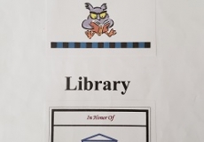 Photo of a bookplate with a cartoon owl and a bookplate with a drawing of a library