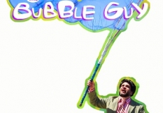 Photo of a man with a large bubble wand making bubbles