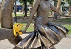 Yellow stuffed monster on the Bewitched statue in Salem