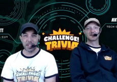 Photo of two men with headsets in front of a sign that says Challenge Trivia